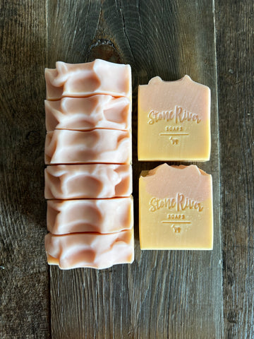 Image shows a group of light peach and orange colored soaps