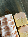 Image shows a group of light peach and orange colored soaps