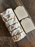 Image shows a group of creamy white salt soaps.