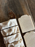 Image shows a group of creamy white salt soaps.