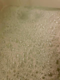 Photo shows bubbly bath water.