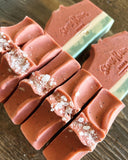 Image shows a group of soap designed to resemble watermelon. Topped with sea salts.