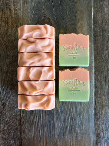 Image shows a group of layered soaps colored orange, yellow and green.