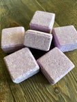 Image shows purple square shaped shampoo bars