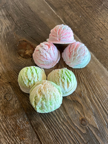 Image shows a group of pink and green and white bubble bath scoops.