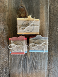 Image shows individually wrapped soaps tied in groups of three.
