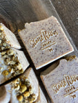 Group of speckled tan soaps with chamomile on top